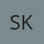 S K