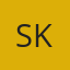 S K